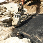 Placing Armour Rock on Geotextile